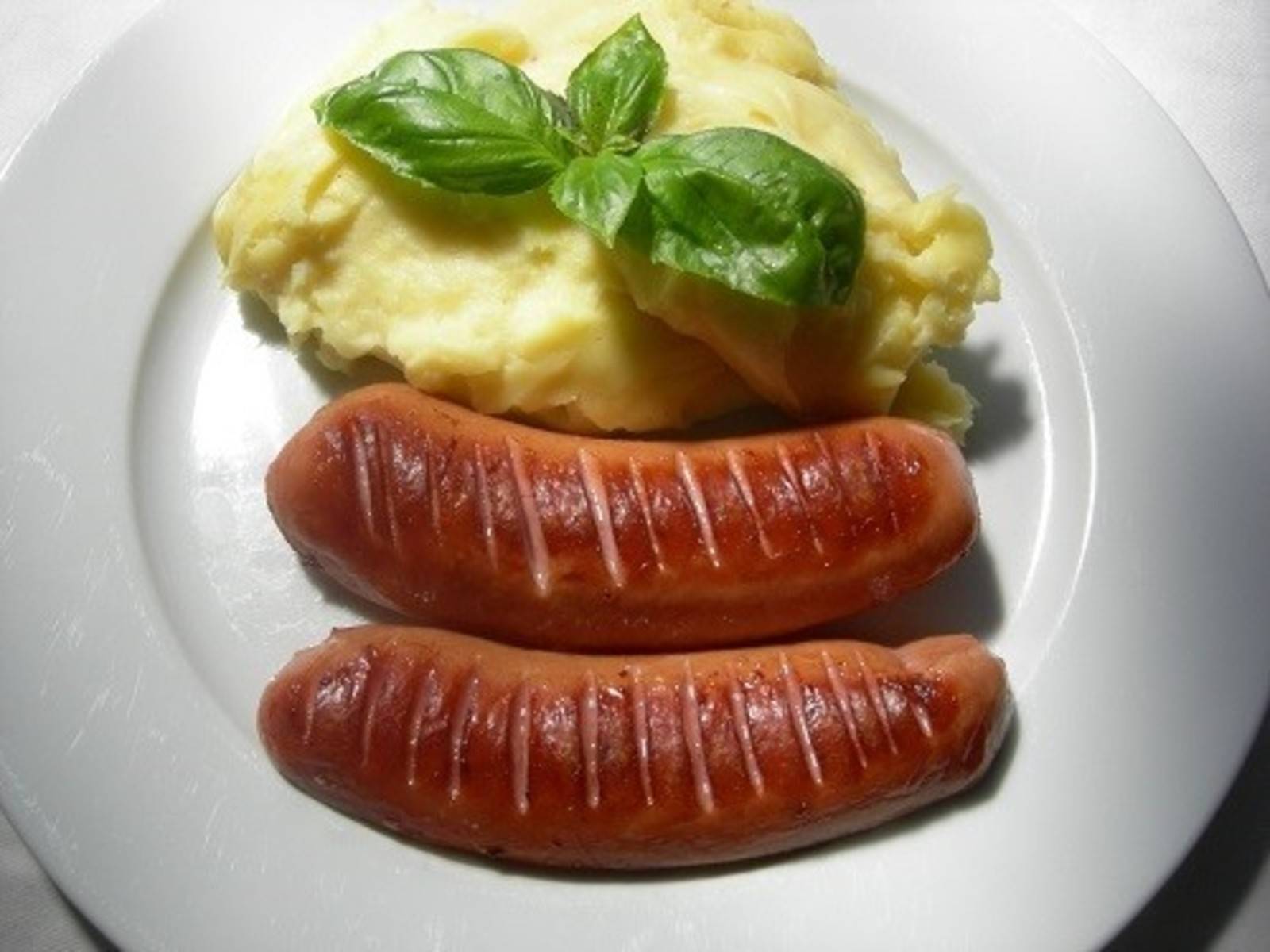 Gebratene Augsburger mit Erdäpfelpüree
